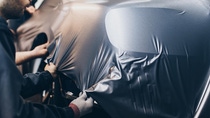 Car wrapping specialist putting vinyl foil or film on car. Car wrapping specialist putting vinyl foil or film on car.