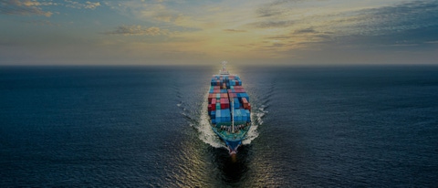A container ship sails across the sea with lubricant components