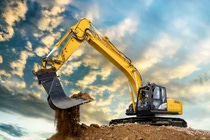 A hydraulic excavator on a mound of earth using  IRGAFLO® Additives  